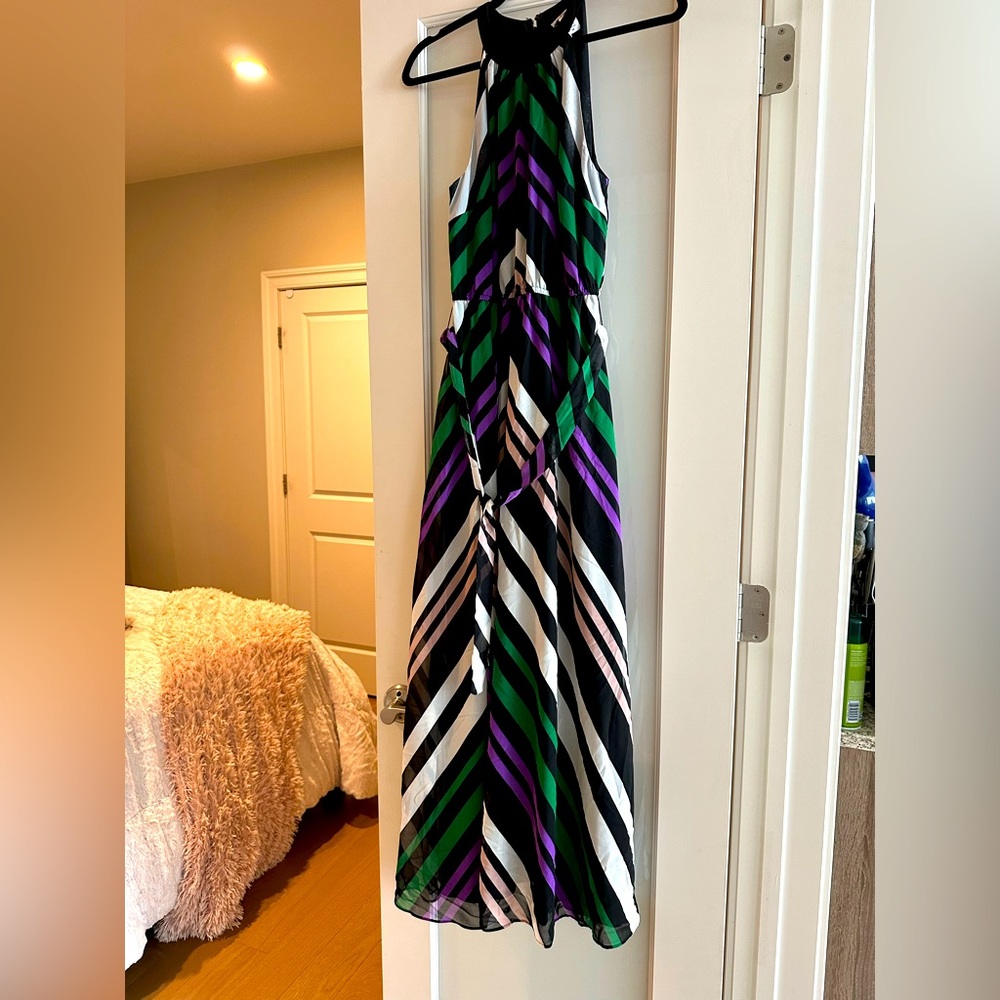 Long purple and green, black maxi dress cinches at the waist with belt